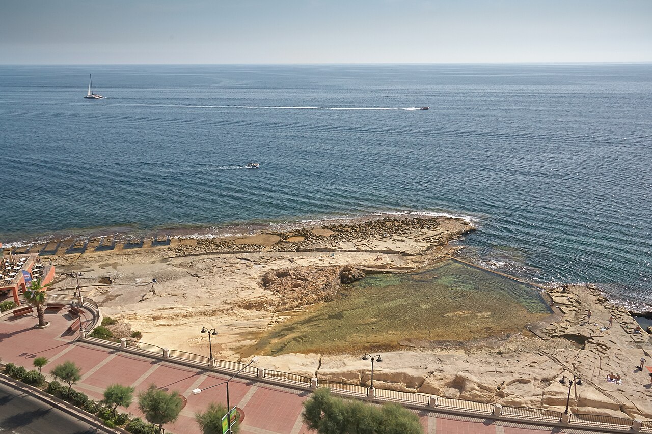 Rocky bathing area and natural pool beside the Sliema promenade,…