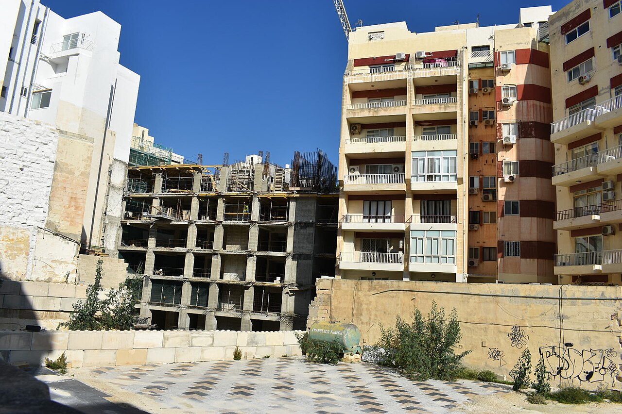 Unfinished concrete building frame on a building site between Sliema…