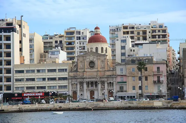 The Strand seafront seen from the water, with a domed parish church between apartment blocks